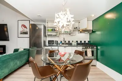 a dining room with a glass table and chairs at Trendy Loft in Downtown in Vancouver