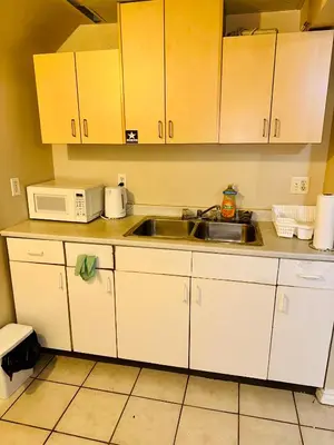 a kitchen with a sink and a microwave at The house Londonderry mall in Edmonton
