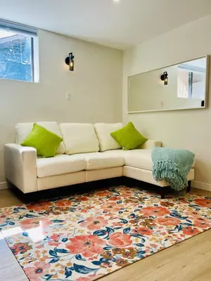 a living room with a couch and a rug at The Chimney Studio with Gigantic Outdoor Fireplace in Calgary