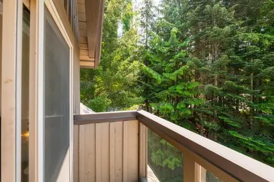 an outdoor balcony with a view of trees at Painted Cliff by Outpost Whistler in Whistler