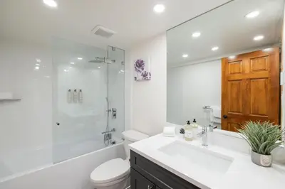 a bathroom with a sink and a toilet and a shower at Painted Cliff by Outpost Whistler in Whistler
