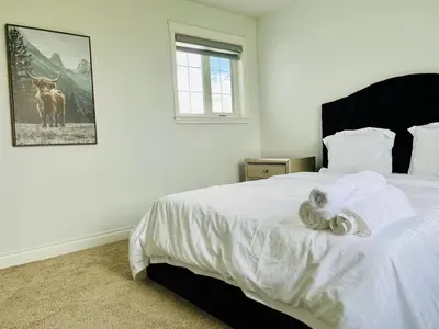 a bedroom with a bed with a stuffed animal on it at Acreage, 5 bdrm, King Bed, AC, Wood Fireplace, Rural in Balzac