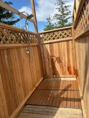 a wooden fence with a shower on it at Cabin with Fields of Dreams in Whitehorse