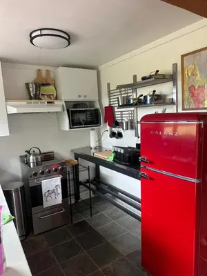 a kitchen with a red refrigerator and a stove at Cabin with Fields of Dreams in Whitehorse