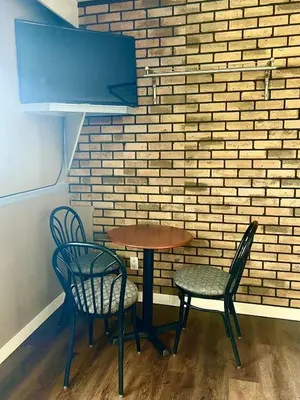 a table and chairs in front of a brick wall at Valemount Hotel in Valemount