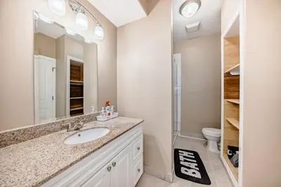 a bathroom with a sink and a toilet at Cozy bedroom in quiet community in Calgary