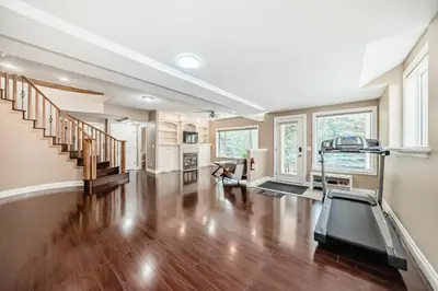 an empty living room with a treadmill in it at Cozy bedroom in quiet community in Calgary