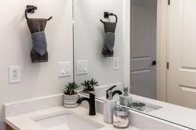 a bathroom with a sink and a mirror at ExoticLUSHquietRetreatKingBed|WIFI|Parking|WEM in Edmonton