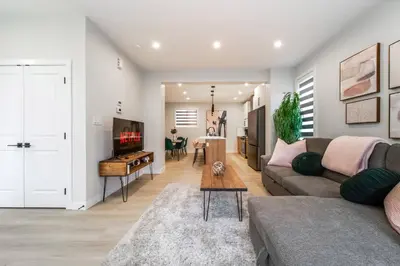 a living room with a couch and a table at ExoticLUSHquietRetreatKingBed|WIFI|Parking|WEM in Edmonton