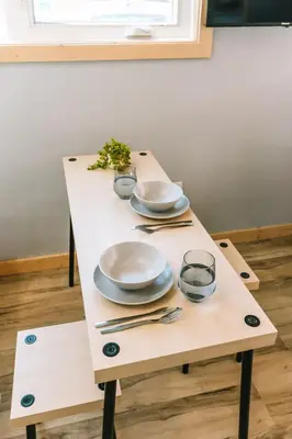 a table with plates and utensils on it at Bikepack Basecamp in Nordegg