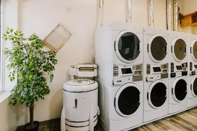 a group of four washing machines in a room at Roamer's Nook in Nordegg