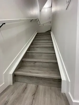 a staircase in a house with wooden floors at Comfy 2 Bedroom Suite Getaway in Edmonton