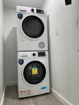 two washing machines are stacked up against a wall at Comfy 2 Bedroom Suite Getaway in Edmonton