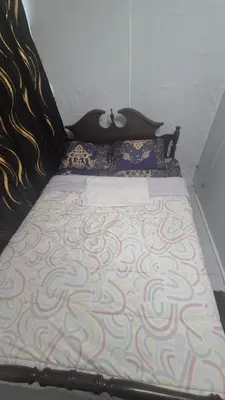 a bed in a bedroom with a swirl patterned blanket at The Peaceful Pines in Terrace