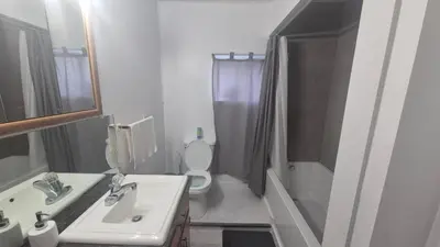 a bathroom with a sink and a toilet and a shower at The Peaceful Pines in Terrace