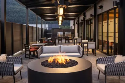 a patio with a fire pit and tables and chairs at Fairfield Inn & Suites by Marriott Chilliwack in Chilliwack