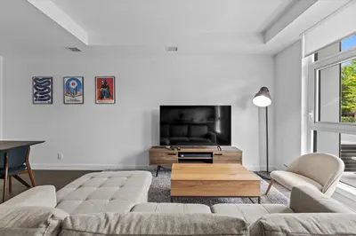a living room with a couch and a flat screen tv at Gyrobeachescape in Kelowna