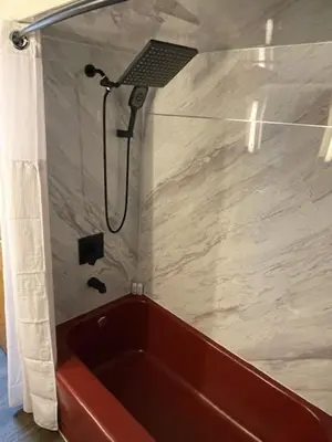 a shower with a red tub in a bathroom at Merlot House in Calgary