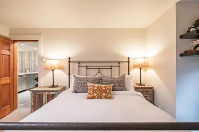 a bedroom with a large bed with two lamps at Arrowhead Point 2 by Outpost Whistler in Whistler