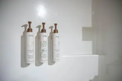 three white bottles are hanging on a wall at Aspens Lodge 220 by Outpost Whistler in Whistler