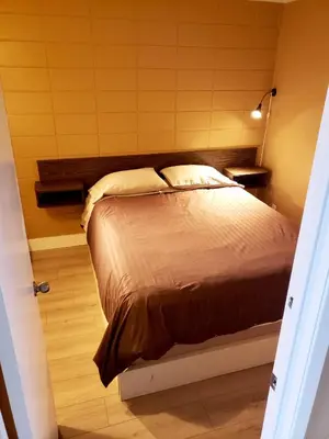 a bedroom with a bed in a room at Above Tide Motel in Campbell River