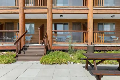 a building with stairs and a bench in front of it at Kootenay Lakeview Resort BW Signature Collection in Balfour