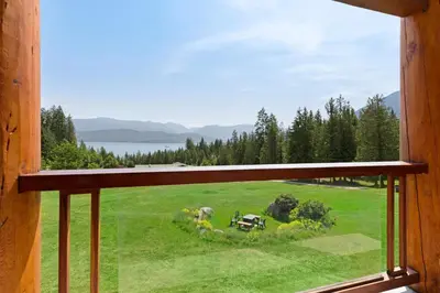 a window with a view of a green field at Kootenay Lakeview Resort BW Signature Collection in Balfour
