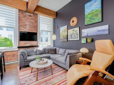 a living room with a couch and a table at Old Town Retreat-your artful escape in Victoria’s historic Old Town by Victoria Prime! in Victoria