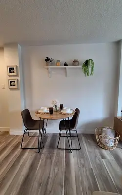 a dining room with a table and two chairs at Modern 1br Apt, Up to 4 people, Steps to 17th Ave, Downtown & Stampede in Calgary