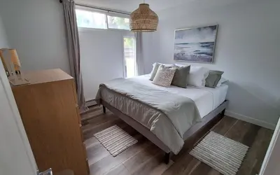 a bedroom with a bed and a window at Modern 1br Apt, Up to 4 people, Steps to 17th Ave, Downtown & Stampede in Calgary