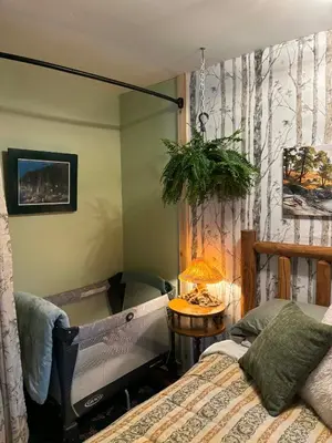 a bedroom with a bed and a table with a lamp at Sea 'N' Stars BNB in Gabriola
