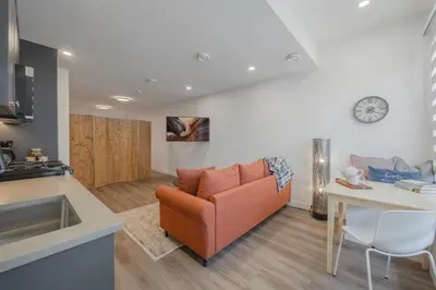 a living room with a couch and a table at Upper and Lower, Great for Large Families, Fenced Yard in Calgary