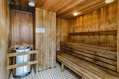 a wooden sauna with a bench and a sink at Modern 2BR 2BA Condo in Heart of Vancouver in Vancouver
