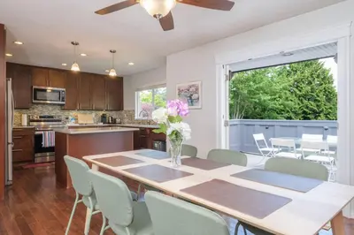a kitchen and dining room with a table and chairs at Surrey Family Home w/ Patio & Garden – 3BR 2BA in Surrey