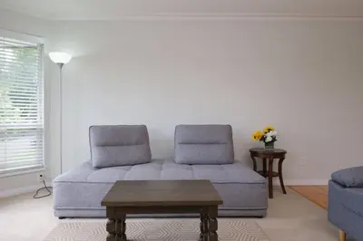 a living room with a couch and a table at Surrey Family Home w/ Patio & Garden – 3BR 2BA in Surrey
