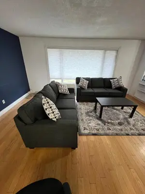 a living room with a couch and a table at Cozy Riverdale Home in Whitehorse