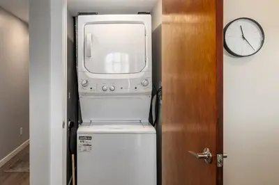 a microwave oven sitting on top of a refrigerator at Knox Mountain Vista 2 Bdrm Suite in Kelowna