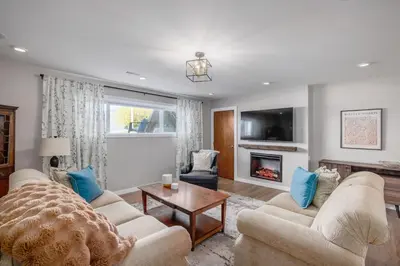 a living room with two couches and a fireplace at Knox Mountain Vista 2 Bdrm Suite in Kelowna