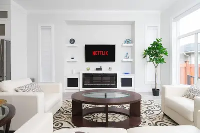 a living room with a tv on a wall at Modern 3BR Near Langley Events Centre & EV charger in Langley