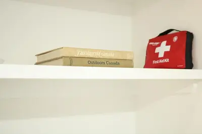 two books and a bag sitting on a shelf at Rustic Rocky Retreat in Calgary