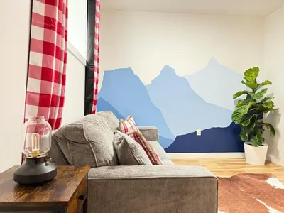 a living room with a couch and a table at Rustic Rocky Retreat in Calgary