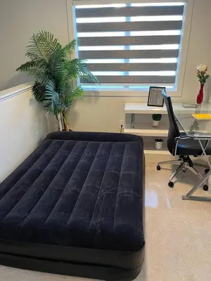 a large bed in a room with a desk and a chair at Full Luxury home 4 BD ,AC,sleep 14,BBQ, 2V Garage in Edmonton