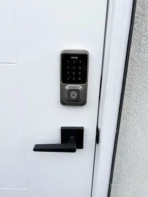 a door lock with a cell phone on it at Bird Nest Suites in Surrey