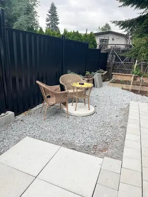 a small patio with a table and a chair at Bird Nest Suites in Surrey
