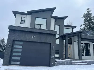a house with a garage door in the snow at Bird Nest Suites in Surrey