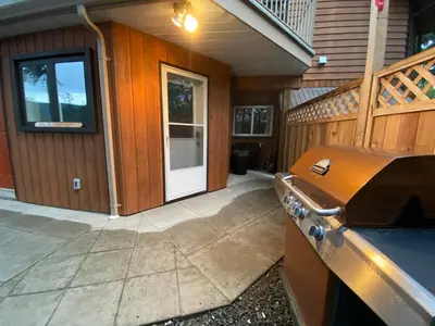 an outside view of a house with a stove at Blind Bay Chalet 2 Bedroom Private Suite in Blind Bay
