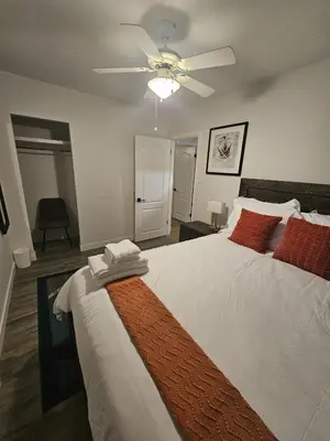 a bedroom with a large bed with a ceiling fan at Aansel Suites 2 bedroom in Edmonton