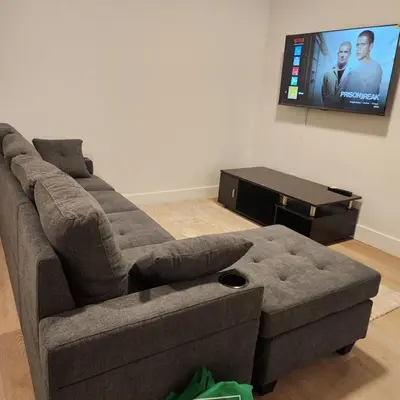 a living room with a couch and a flat screen tv at Spacious 2 Bedroom Suite in Gorman, Edmonton, Canada in Edmonton