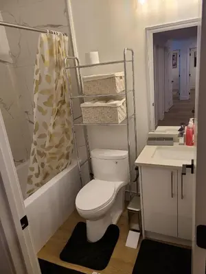 a bathroom with a toilet and a sink at Spacious 2 Bedroom Suite in Gorman, Edmonton, Canada in Edmonton