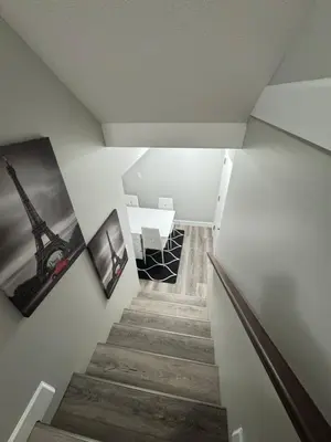 a stairway with a picture of the eiffel tower at True Haven in Prince George
